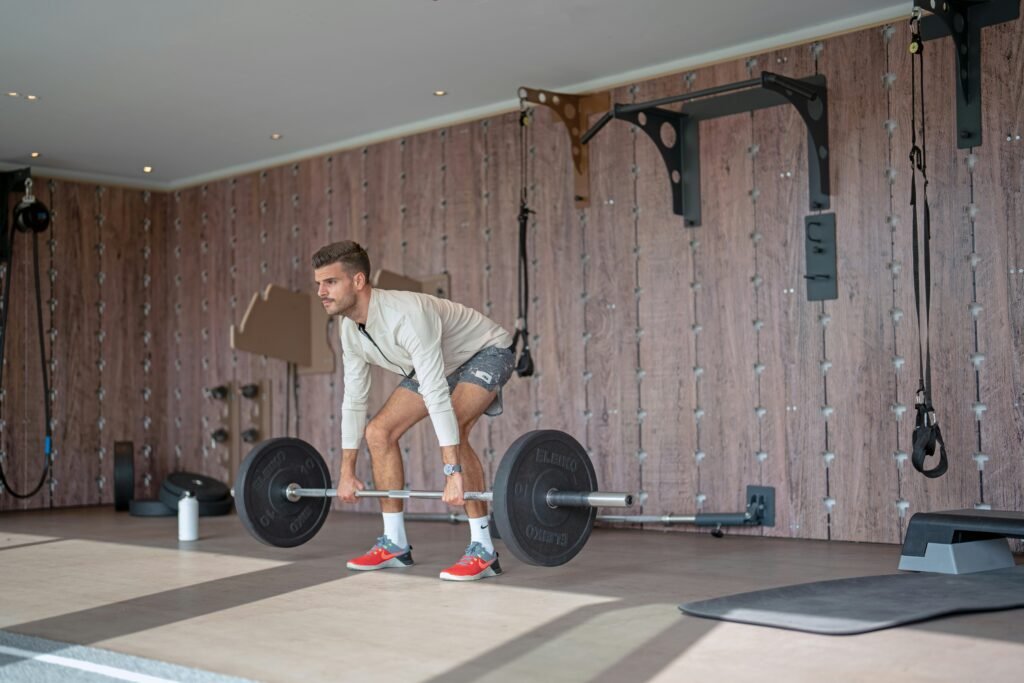 man performing deadlift exercise in a home gym during an upper lower split program